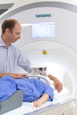 Superintendent Radiographer putting patient into MRI machine